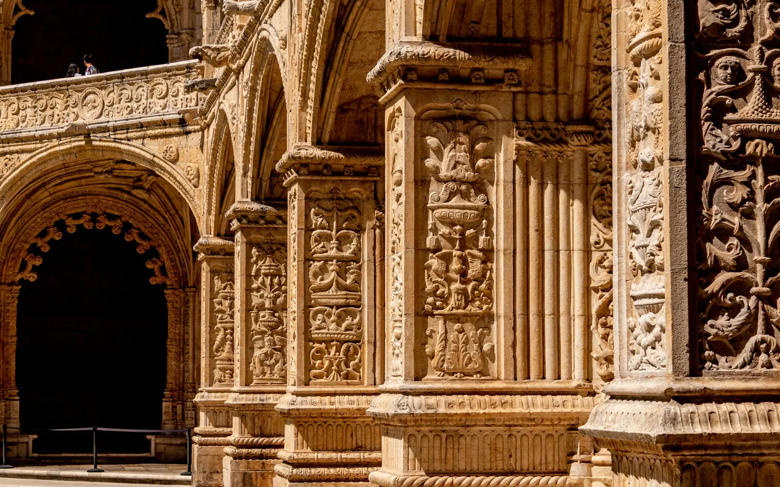 The south portal of the Jerónimos Monastery, a wall of carved limestone figures rising above the doorway